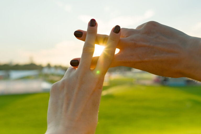 hashtag sign made with hands in sunlight